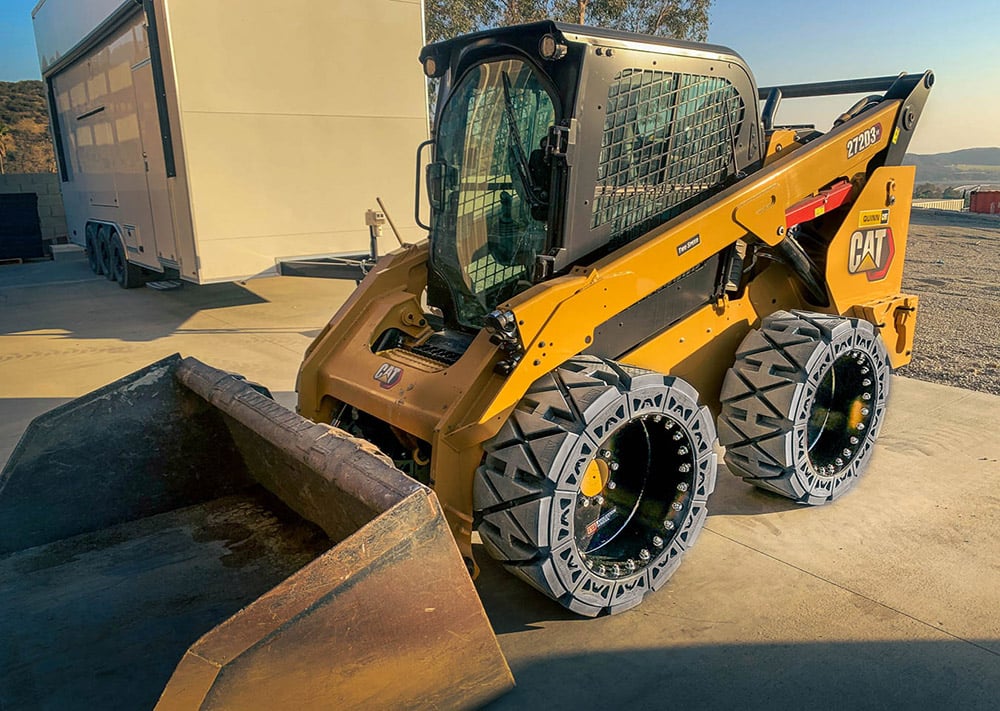 This images shows our non marking solid skid steer tires on a CAT skid steer.
