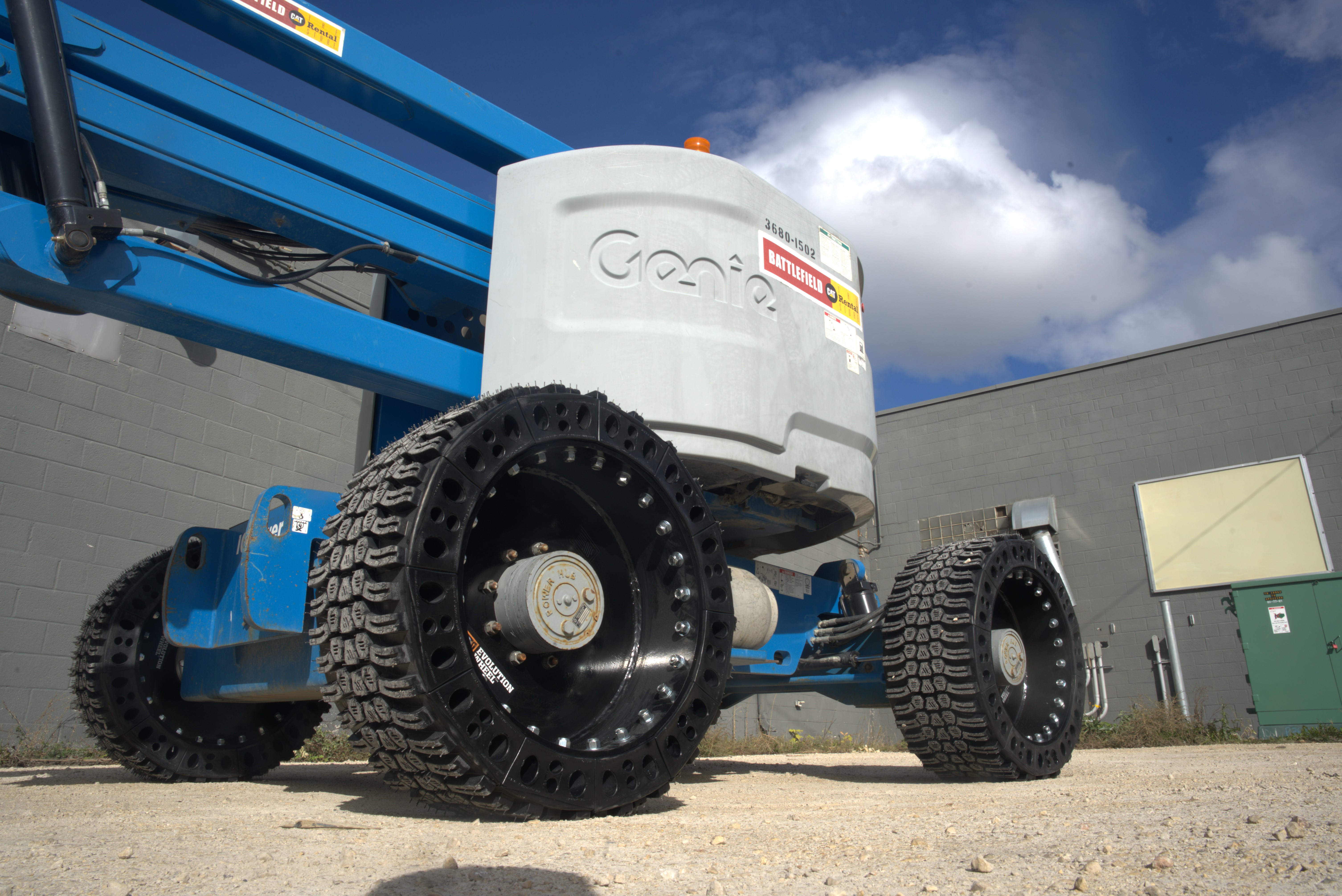 This image shows a blue Genie aerial work platform using our EWRS-AWP solid aerial work platform tires.