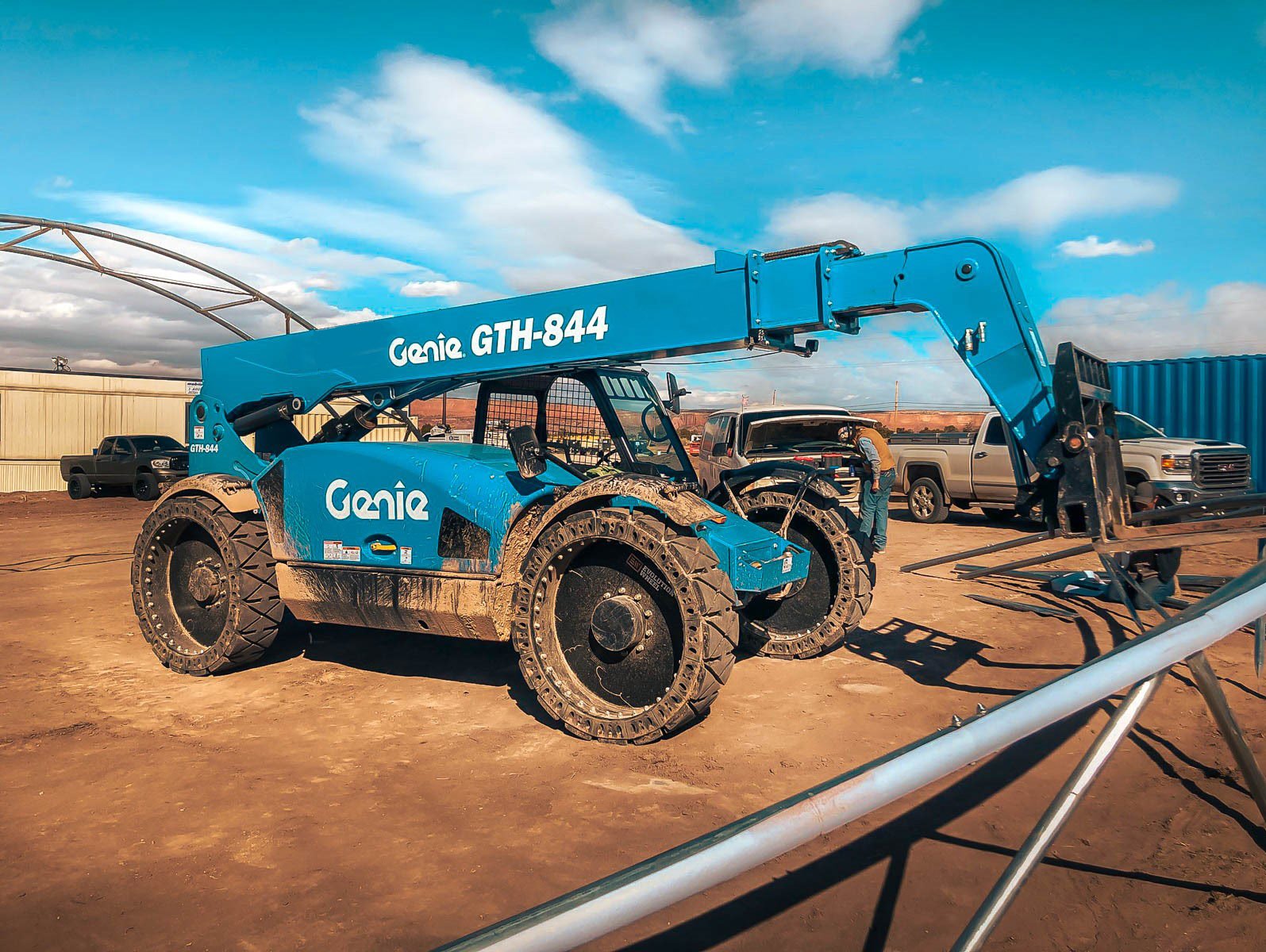 This picture shows our telescopic forklift tires on a blue Genie telehandler