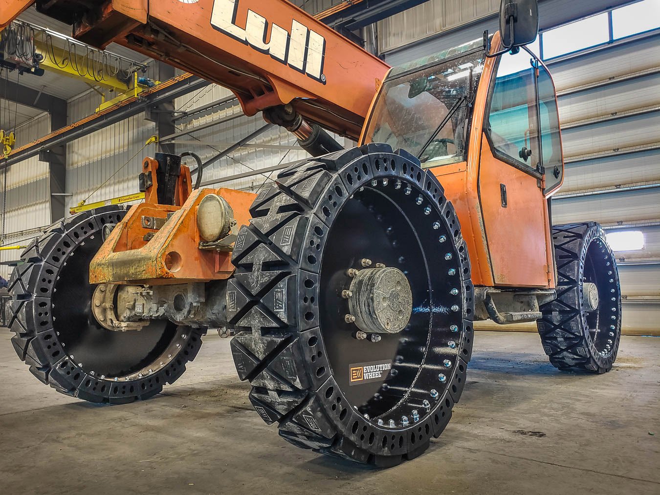 This picture shows a solid telehandler tire on an orange Lull telehandler