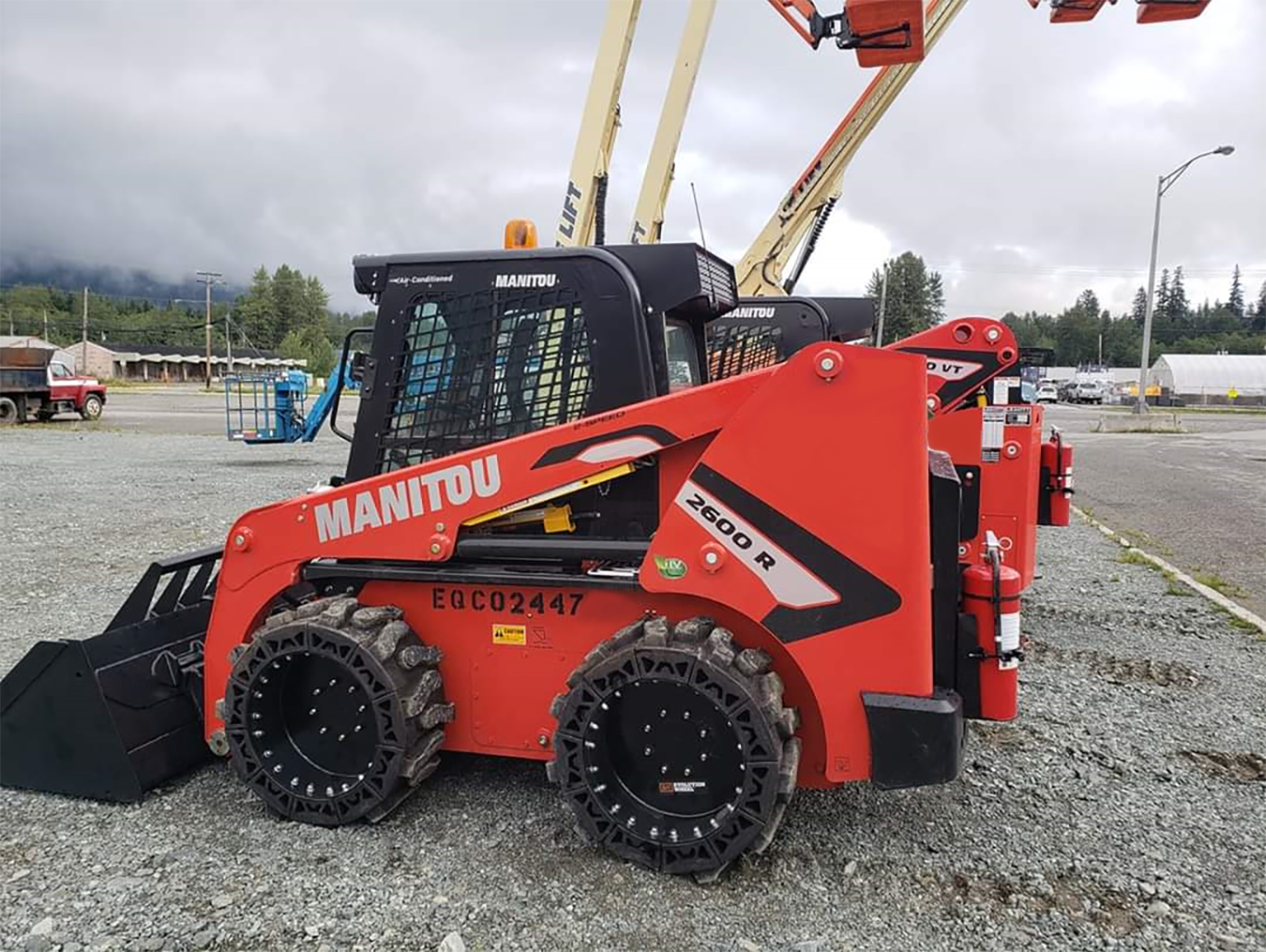 This image is about a Red Manitou Skid Steer using our flat free skid steer tires.
