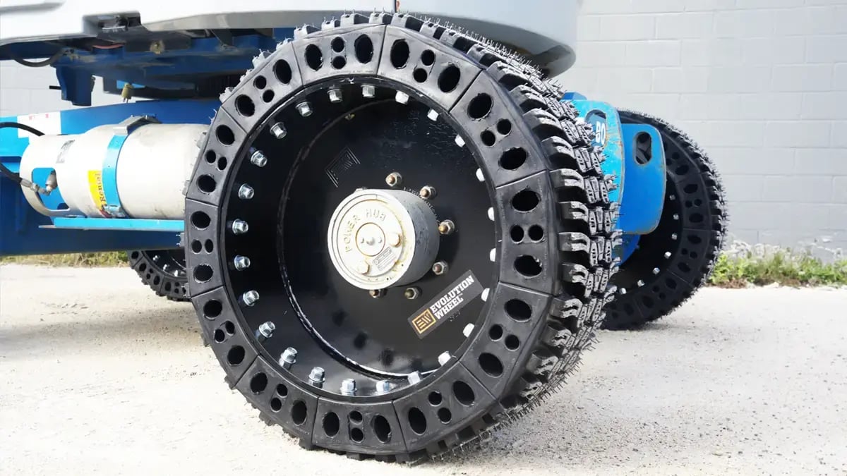 Side profile of a Genie telescopic boom lift featuring 12-16.5 flat free tires from Evolution Wheel to prevent job site downtime.