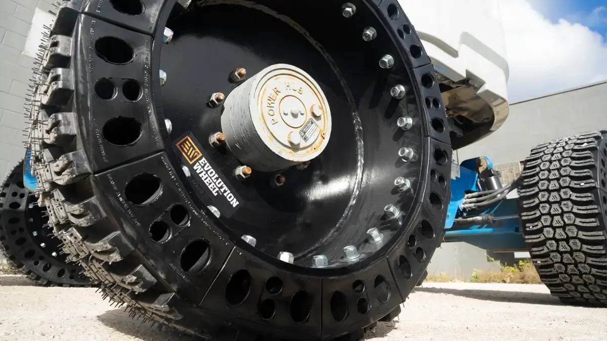 Close up view of the modular segment design on a 12-16.5 airless AWP tire installed on a Genie aerial work platform.