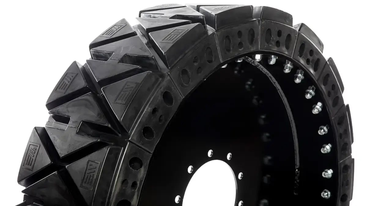 A close up view of the thick hard surface tread pattern on a 14x24 solid telehandler tire
