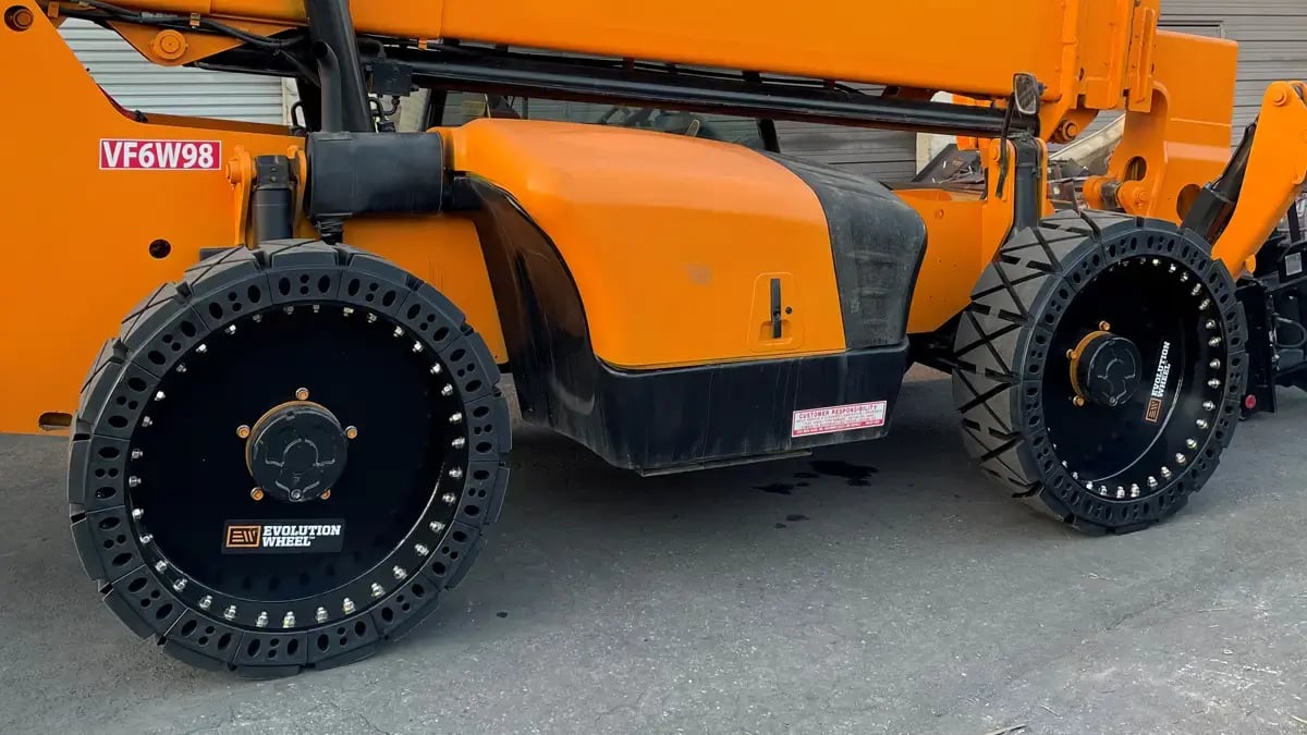 A heavy duty telehandler machine working outdoors on solid terrain.
