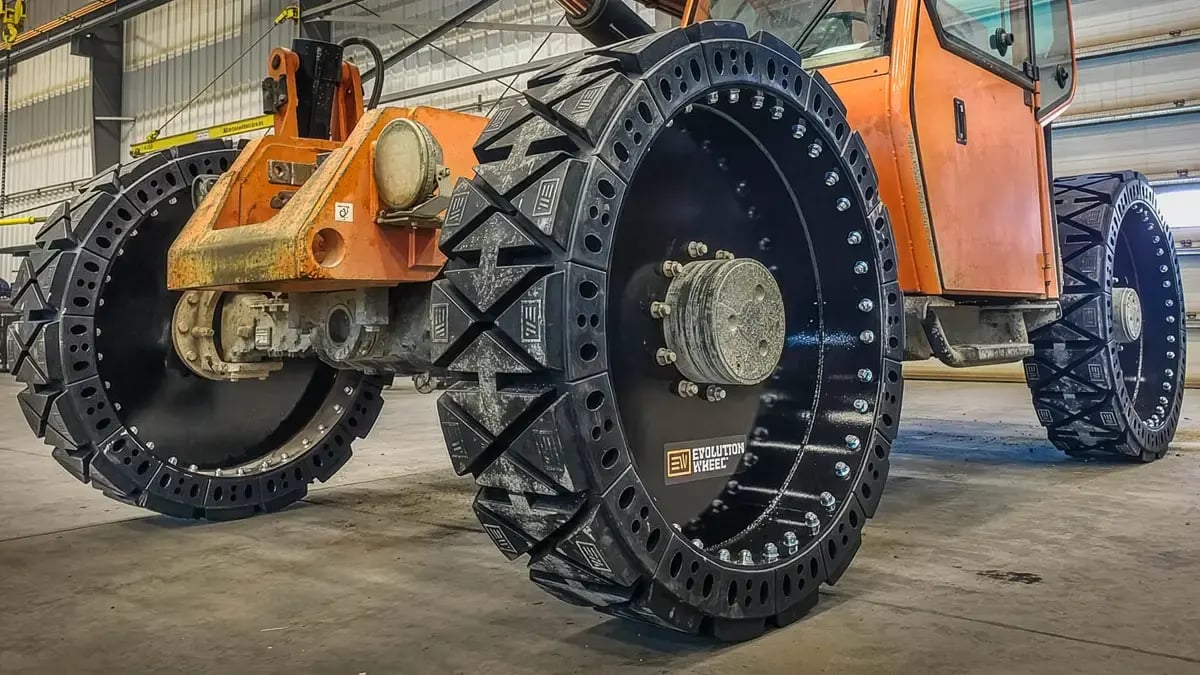 A telehandler equipped with EWRS-TH-HS airless solid tires lifting materials on a job site