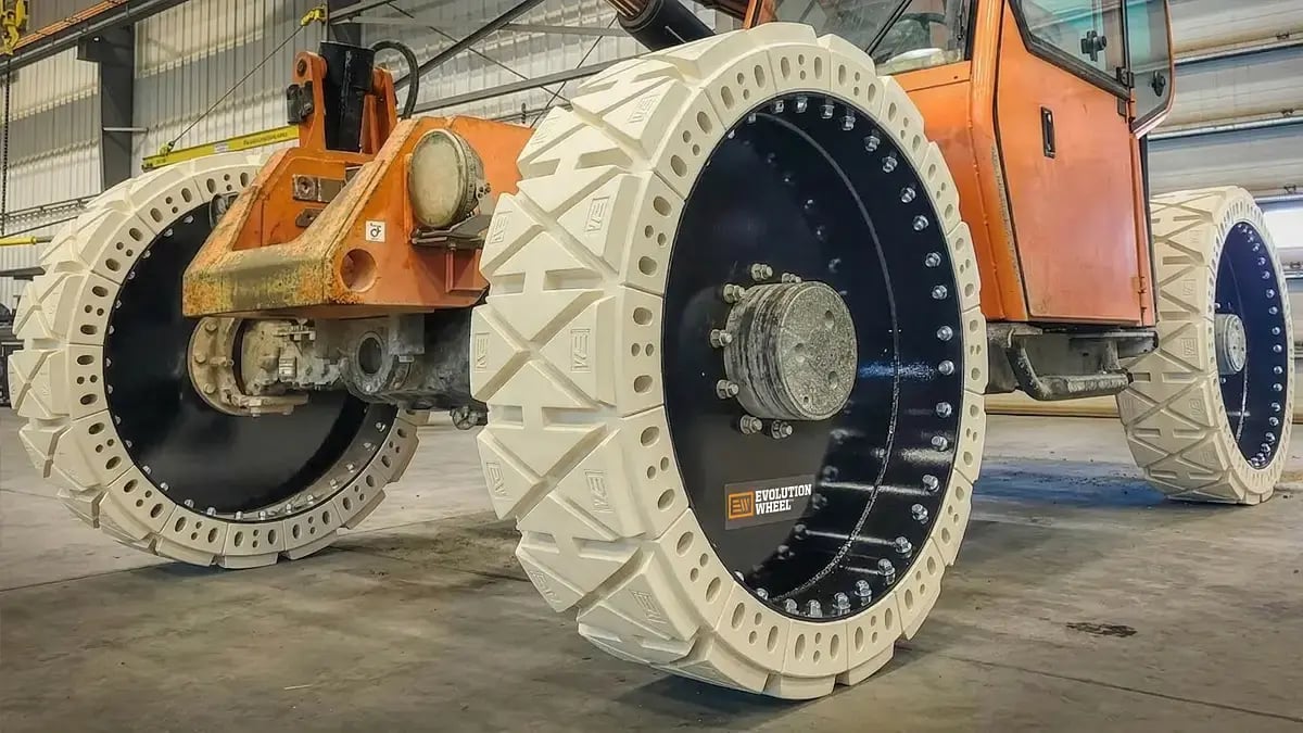 Detailed view of the specialized gray non-marking rubber tread on a 14x24 airless telehandler wheel designed for indoor surface protection.