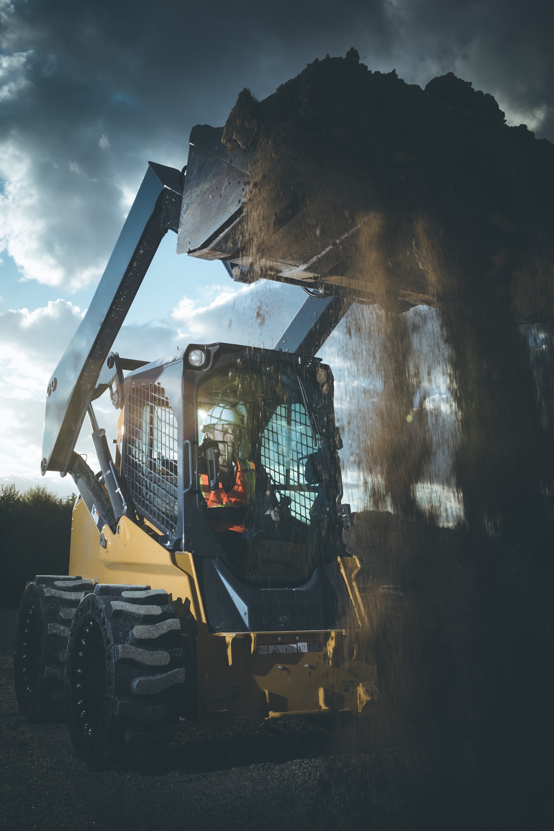 This image shows a skid steer machine using our EWRS-At solid skid steer tires on a jobsite. 